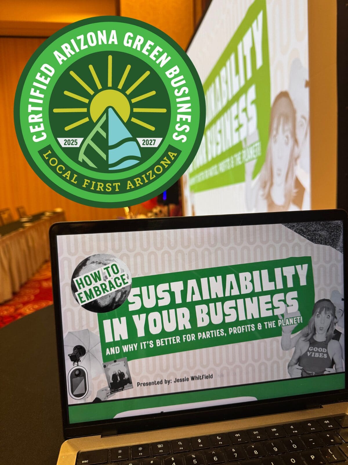 Photo of MISGIF’s sustainability presentation at the largest photo booth conference in the world. A laptop screen displays the slide titled “How to Embrace Sustainability in Your Business and Why It’s Better for Parties, Profits & the Planet,” presented by Jessie Whitfield. In the background, the same slide is projected on a large screen. Overlaid in the top left corner is the Local First Arizona Certified Green Business badge for 2025–2027.